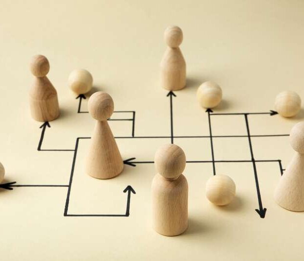 Pieces on a playing field with arrows representing strategic planning