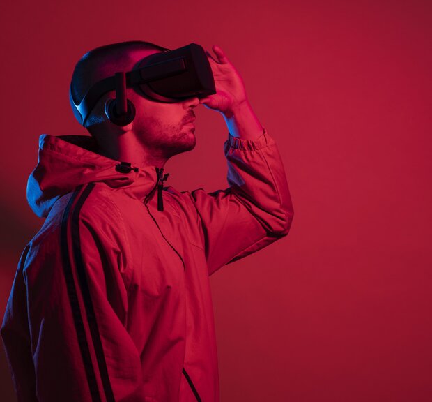 Man with VR glasses on a red background